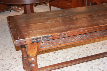 Large rustic table from the early 19th century, extendable embellished with carving motifs