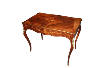 French Louis XV style desk with rich marquetry patterns and gilt bronze applications