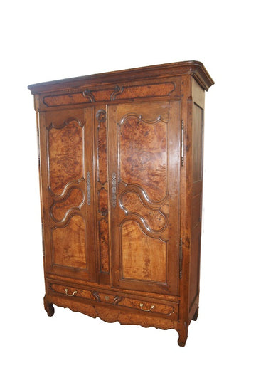 French Provençal wardrobe from the late 1700s in walnut wood with carvings