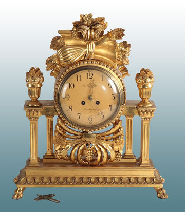 Antique Northern European table mantel clock from 1900 in gilded wood