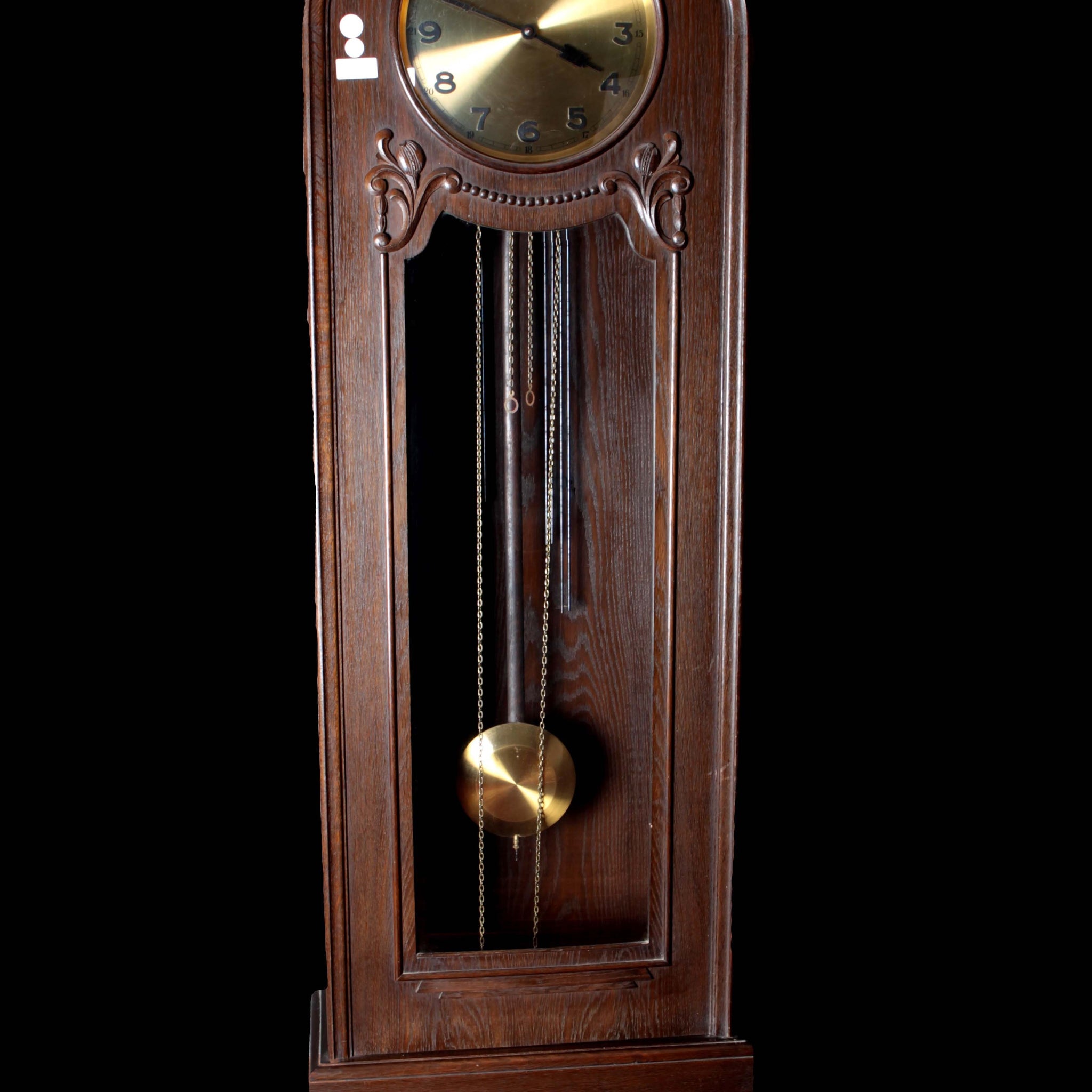 Art Deco style column clock in carved oak, from the early 1900s