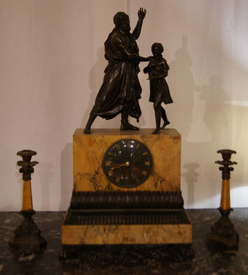 Ancient mantel clock in yellow Siena marble and mythological bronzes