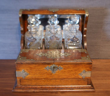Antique English liquor holder from the 1800s with crystal bottles
