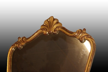 Specchiera francese di inizio 1900 sagomata e dorata foglia oro