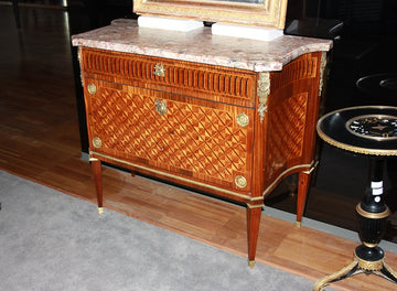 French Louis XVI chest of drawers from the 1800s richly inlaid with wavy sides