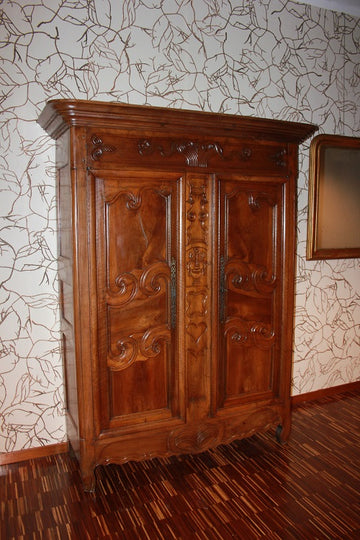 Graceful French Provençal slim Wardrobe from the 1700s in walnut wood with rich carving motifs
