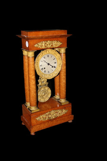 French Empire style mantel clock in elm root with bronze applications and richly finished pendulum