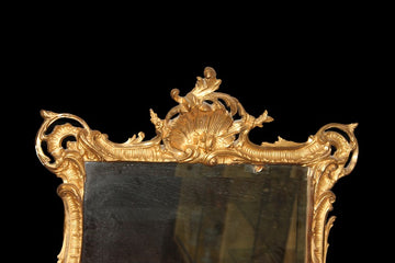 Elaborate French mirror from the early 1800s in gilded gold leaf