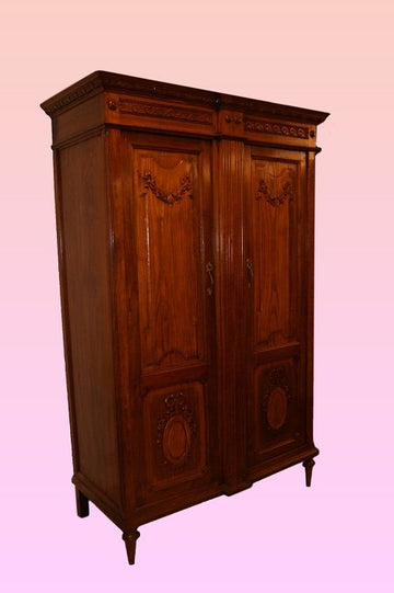 Antique French wardrobe from 1800 Louis XVI style with carvings