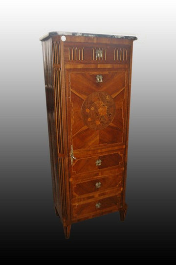 Detail of small chest of drawers with richly inlaid door in Louis XVI style from 1800