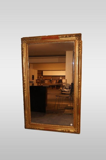 Rectangular symmetrical Louis XVI style mirror in gold leaf