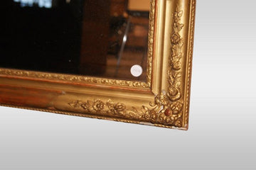 Rectangular symmetrical Louis XVI style mirror in gold leaf