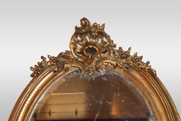 Golden French oval mirror with cymatium