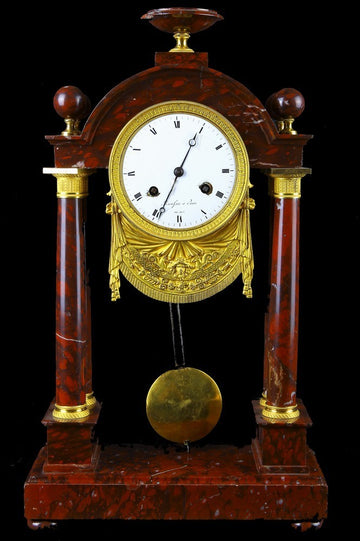 Antique French red marble empire style mantel clock from the mid 1800s