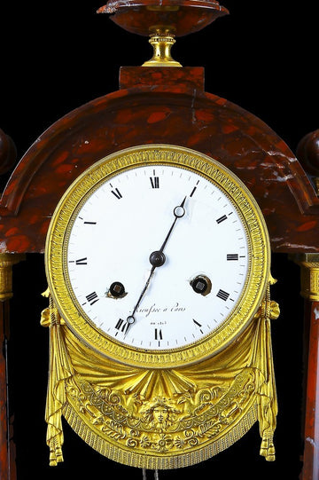 Antique French red marble empire style mantel clock from the mid 1800s