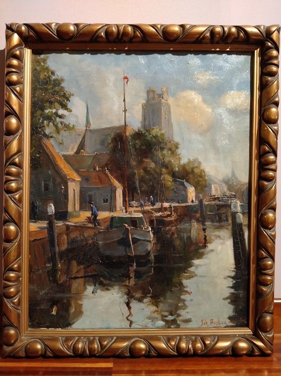 Antique oil on canvas depicting a dock and moored boats from 1900