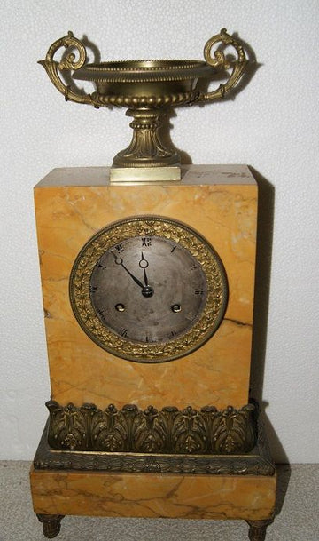 Antique French Empire style mantel clock from 1800 in marble with bronzes