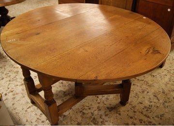 Antique French oval solid oak table from the 19th century with wings