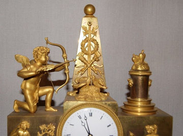 Impero table mantel clock with cupid and muses in mercury-gilt bronze
