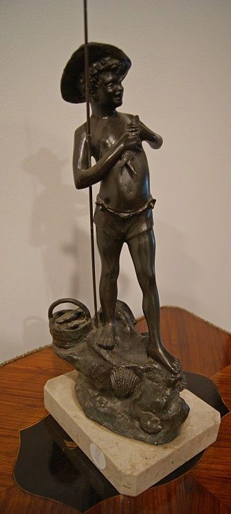 Antique French metal sculpture from the 1800s depicting a fisherman