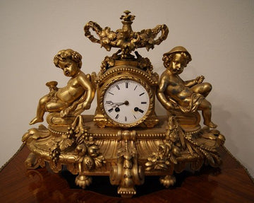 Antique French mantel clock from the 1800s in gilded bronze with cherubs