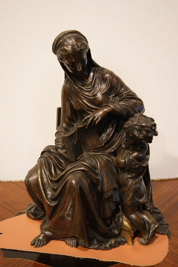 Bronze sculpture depicting motherhood