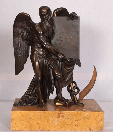 Orologio con scultura in bronzo di Crono dio del tempo e base in marmo giallo Siena