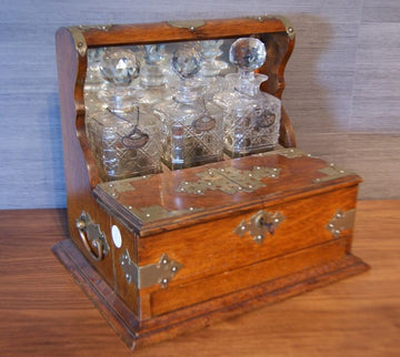 Antique English liquor holder from the 1800s with crystal bottles